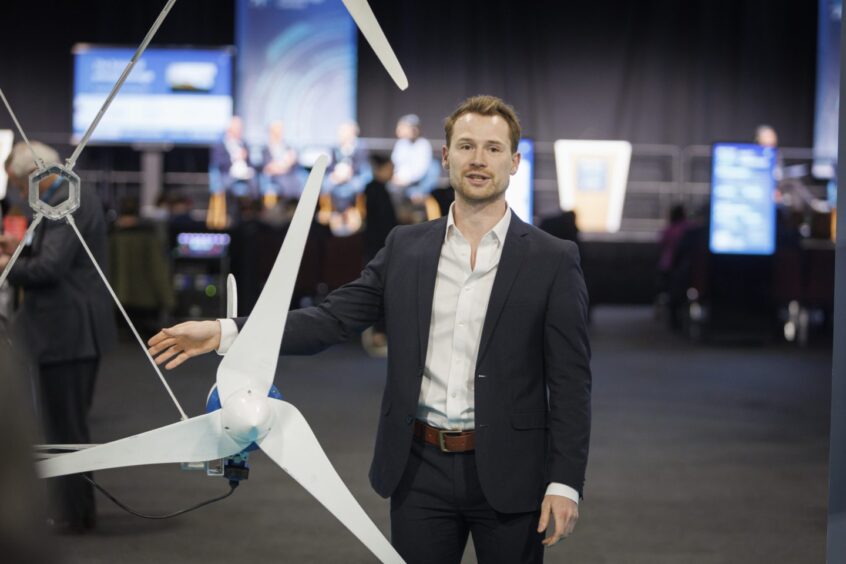 Adam Harris, CEO of Myriad Wind Energy Systems, demonstrates their multi-rotor wind turbines
