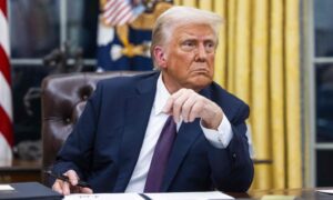 US President Donald Trump issued numerous executive orders on the first day of his presidency in the Oval Office of the White House in Washington, DC.