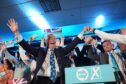 Reform UK party leader Nigel Farage with his party's candidates onstage during a campaign event at Stafford Showground. Image: Jacob King/PA Wire