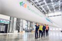 Group looks over a wind turbine blade.