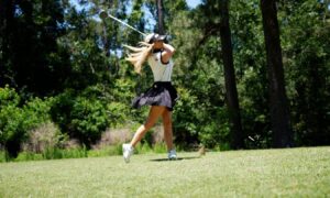 Action shot of Jennifer Hall playing golf.