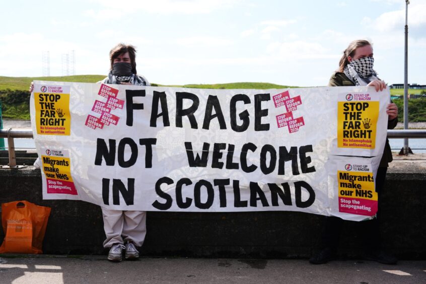 Protesters in Aberdeen ahead of a Reform UK press conference featuring Nigel Farage. 
Image: Stuart Wallace/Shutterstock