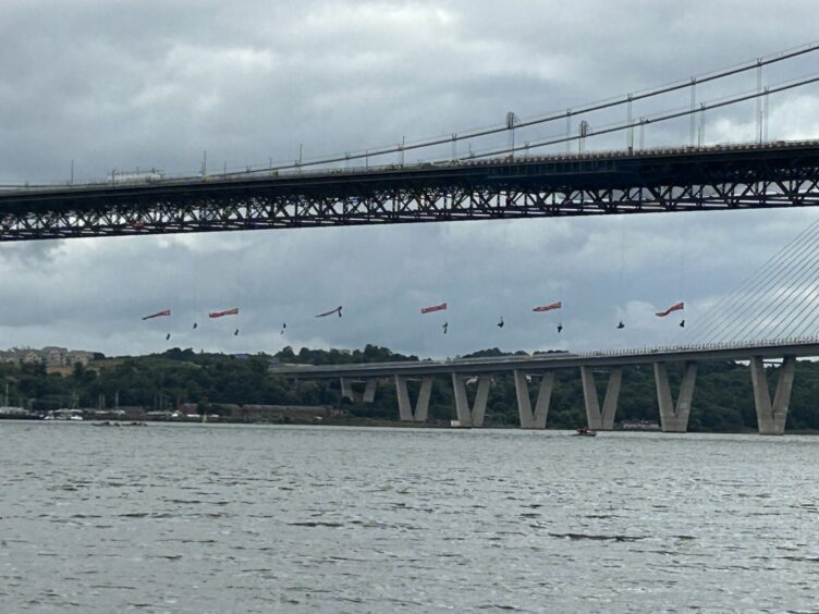 Greenpeace protestors suspended from the Forth Road Bridge.