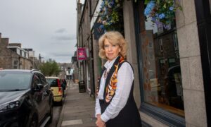 Jeanette Forbes stands outside her Thistle Street restaurant, Mediterranean.