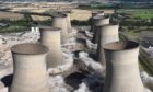 An overhead view of the moment eight cooling towers at the decommissioned Cottam coal power station are brought down by controlled explosives. Image: Brown & Mason