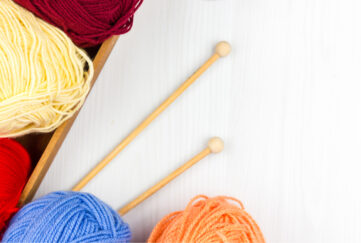 Knitting yarn flatlay, multicoloured yarn and needles