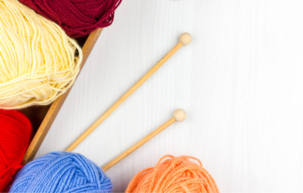 Knitting yarn flatlay, multicoloured yarn and needles