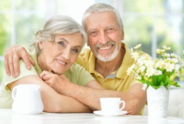 A happy older couple drinking tea at home