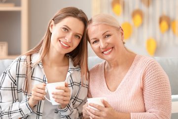 Mum and adult daughter drinking tea together