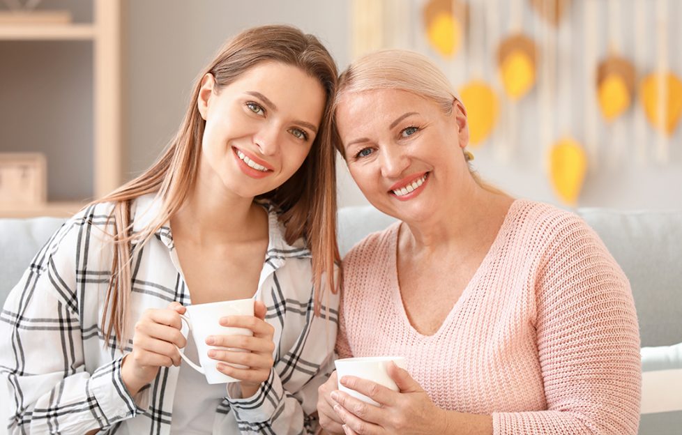 Mum and adult daughter drinking tea together