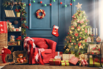 A living room decorated for Christmas with tree, stocking, presents, garland and wreath