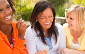 Three female friends laughing together