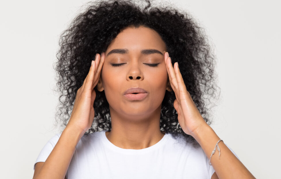 Woman rubbing temples and being calm