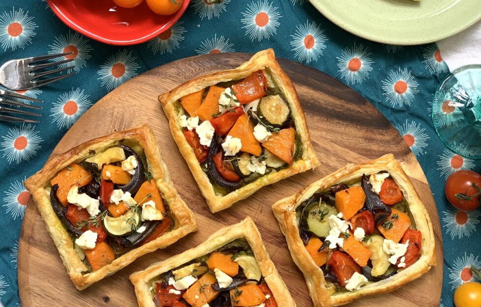 Four roasted vegetable, pesto and feta tarts flatlay