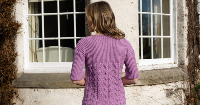 Back view of knit, mauve knitted lace and rib top