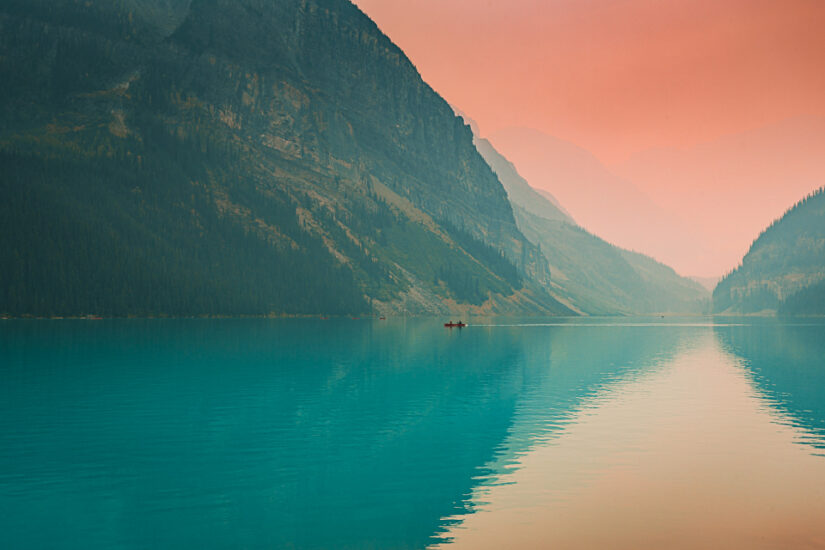 ‘Swallowing mountains’. The pastel-coloured sky and sea shines a light on two rowers as they head in-between mountains. Captured by Wolfgang Hansen, taken in Lake Louise, Canada. Provided by The CEWE Photo Award.