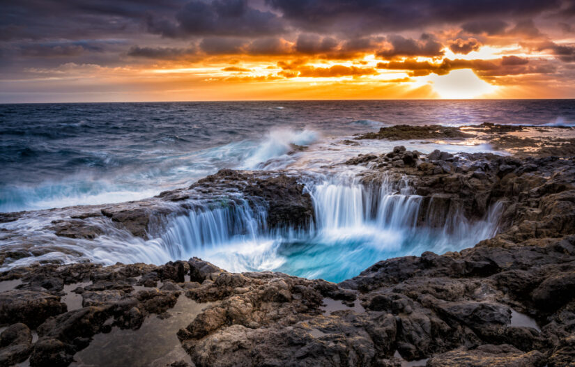 ‘The Blowhole’. Crystal blue water descends into a rocky pool as the sun sets on another day. By Michael Kutscher, taken in El Bufadero, Spain. Provided by The CEWE Photo Award.