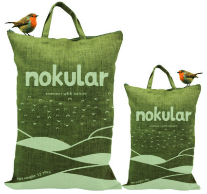 Nokular jute sacks of bird feed with robins