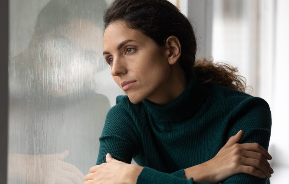 Woman gazing out of window