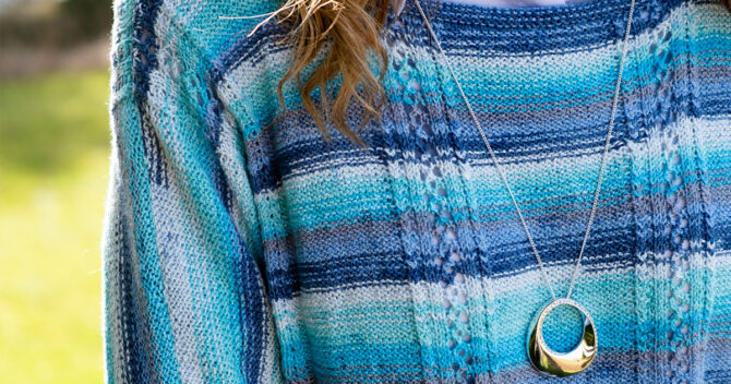 June 25 Knitted Top Preview: close up of blue striped knitted top pattern with necklace