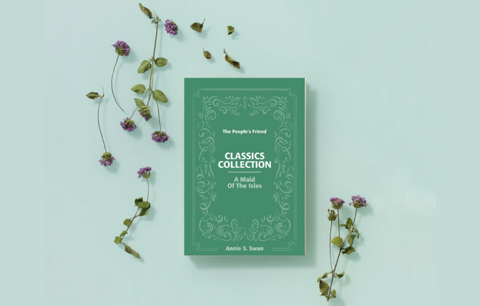A Maid of the Isles by Annie S. Swan Classics Collection paperback cover flatlay with flowers