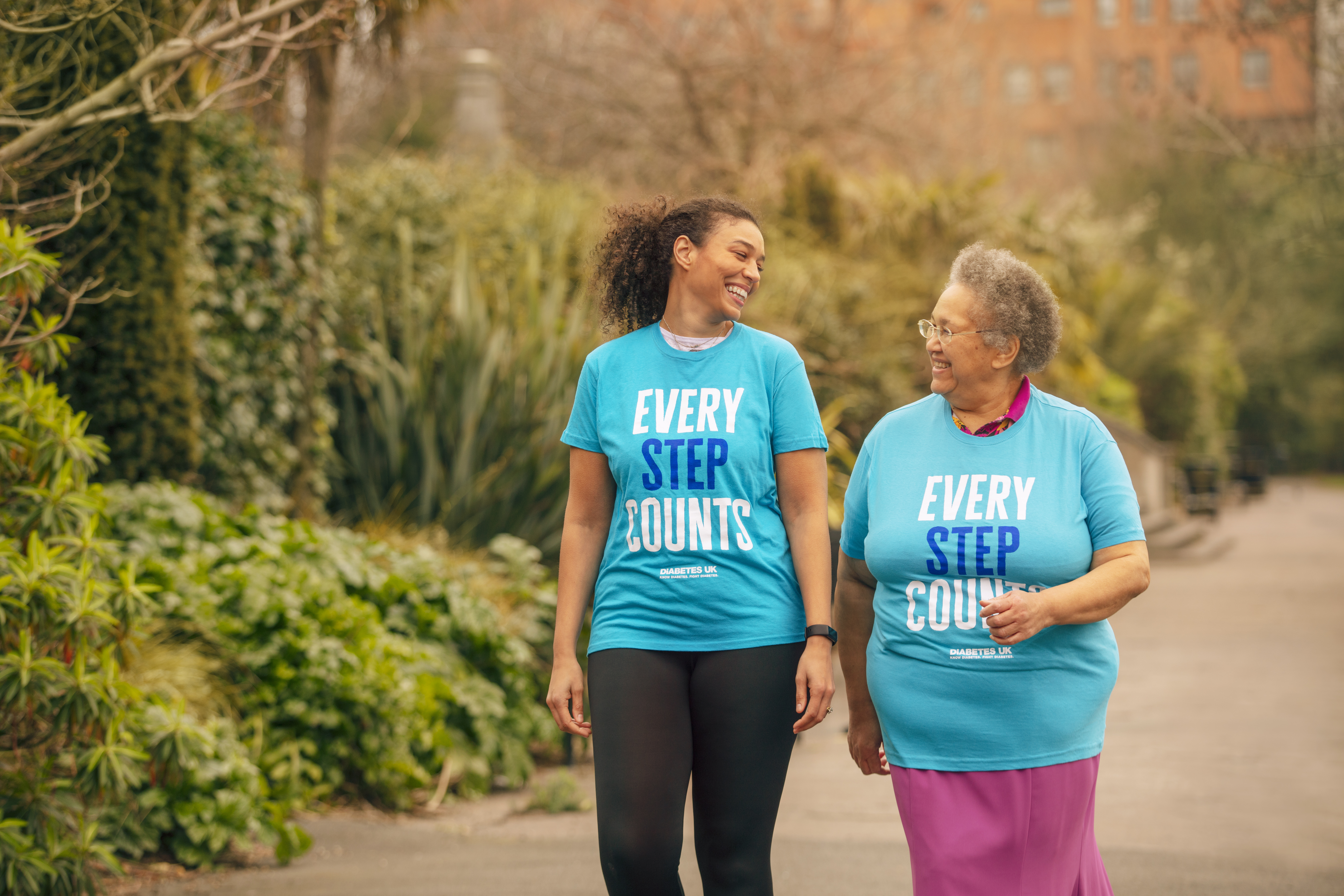 Two women taking part in One Million Step for Diabetes UK, wearing blue 'every step counts' shirts