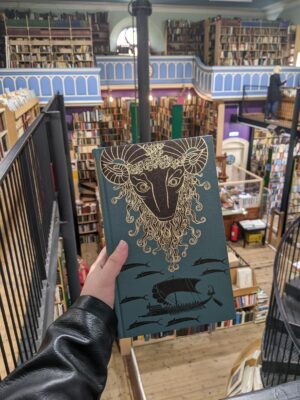 Leakey's Bookshop, Inverness view of store holding a book in the foreground, The Golden Fleece by Robert Graves