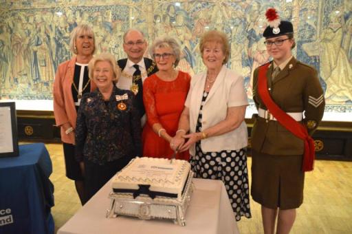 A group from Coventry Resource Centre for the Blind, including Rosie Brady, cutting cake for an event