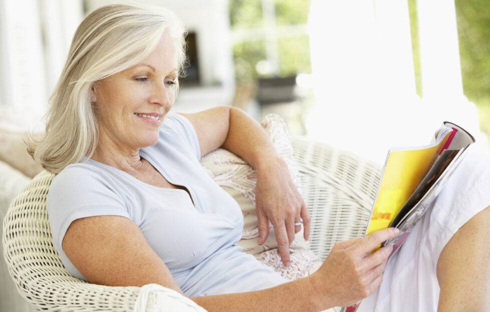 Woman relaxing and reading a magazine