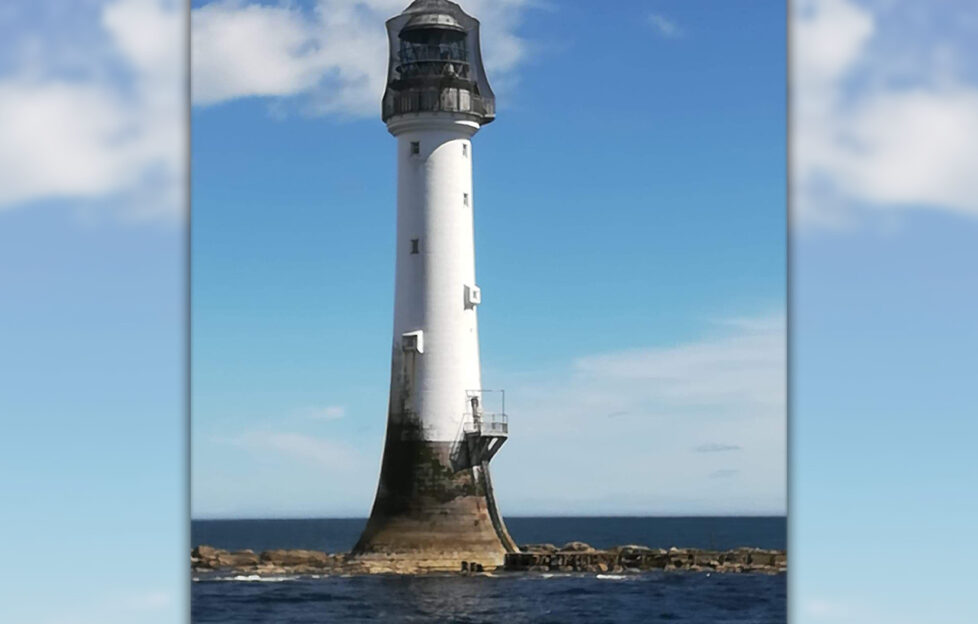 The Bell Rock Lighthouse against blue sunny sky