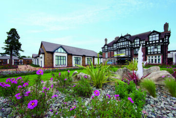 Warner Holiday Alvaston Hall Hotel, Cheshire, view of building exterior with flowering garden in foreground