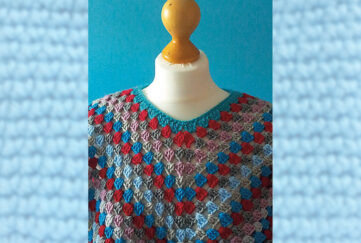 Red and blue crochet poncho on mannequin