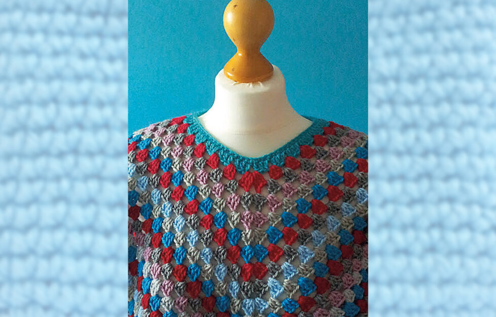 Red and blue crochet poncho on mannequin