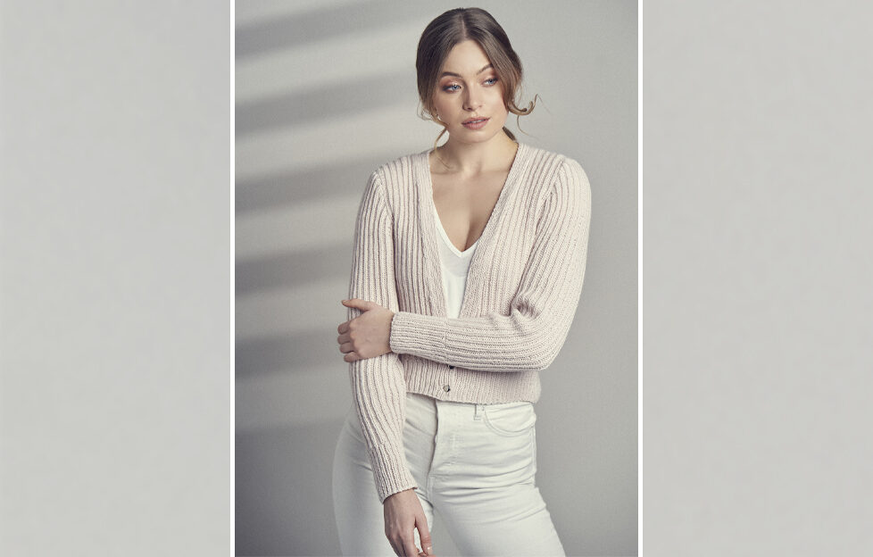 Model wearing cashmere cardigan frontal view on soft grey background