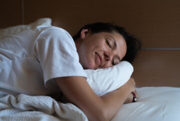 woman sleeping hugging pillow