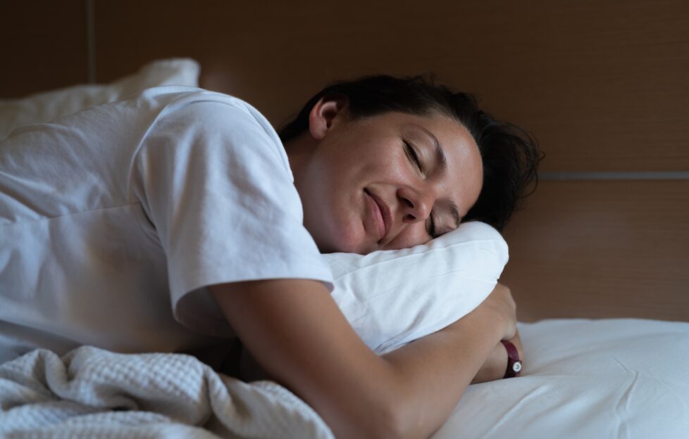 woman sleeping hugging pillow