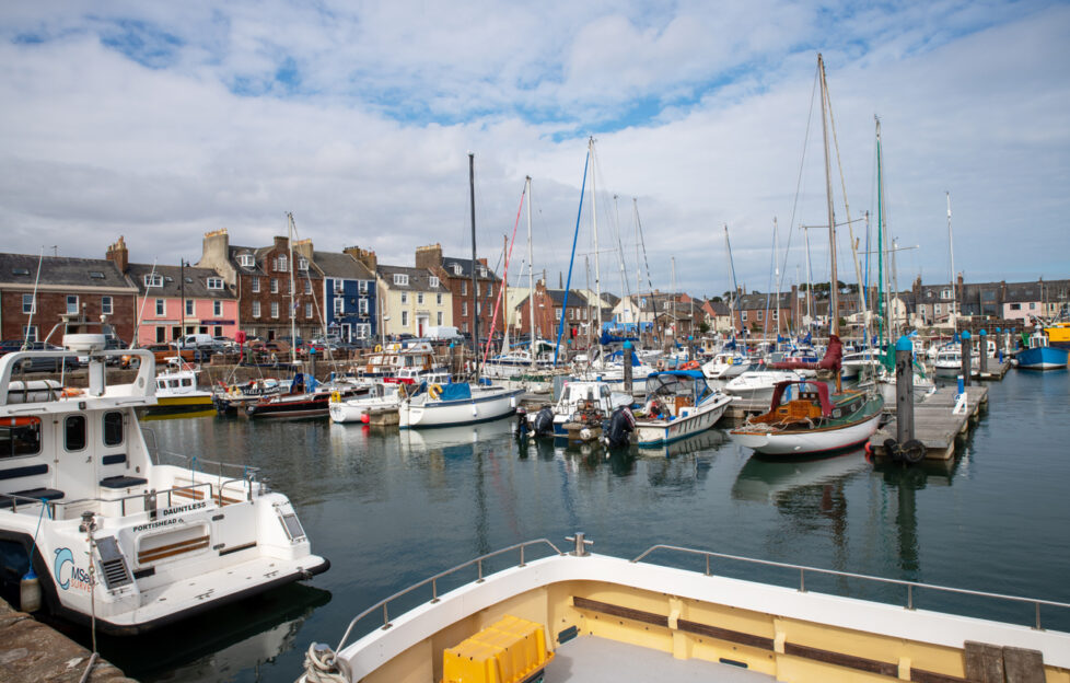 A view of Arbroath Harbour full of boats on a sunny cloudy day