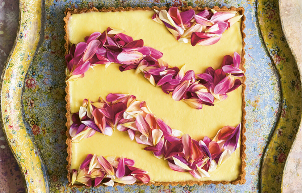 Milk Tart top down view, square tart filled with topping and decorated with pink flower stripes