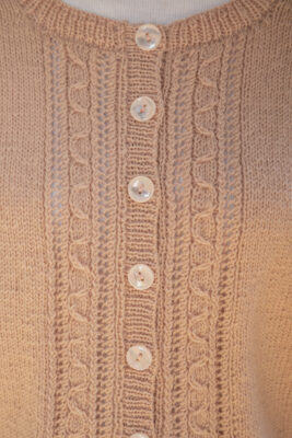 Close up of knitted cardigan pattern and buttons
