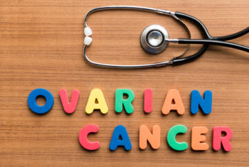 'Ovarian cancer' spelled with colourful letters on a table with a doctor's stethoscope