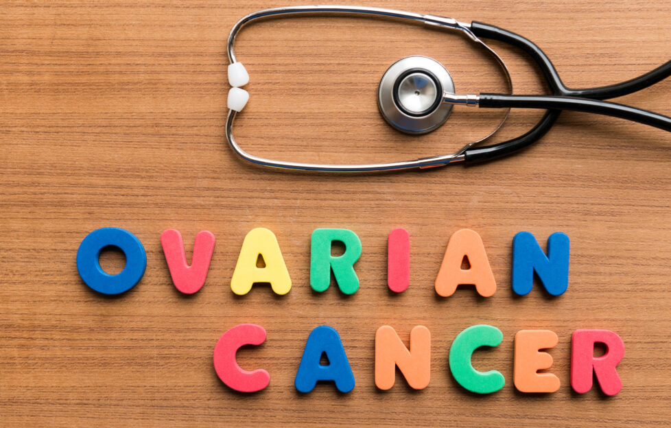 'Ovarian cancer' spelled with colourful letters on a table with a doctor's stethoscope