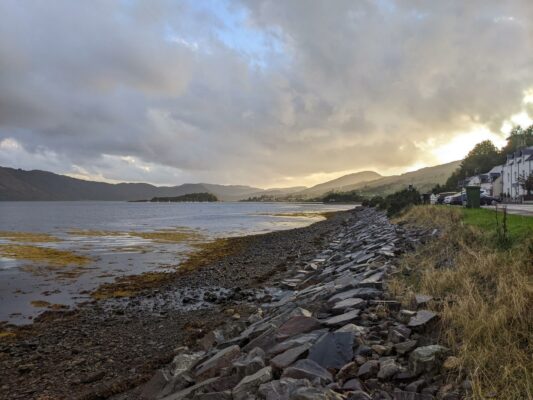 A view of Lochcarron down the main street and loch as the sun sets