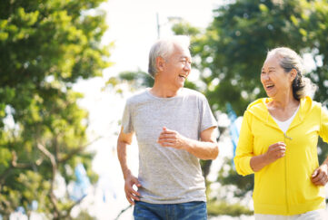 Mature Asian couple jogging outside for exercise