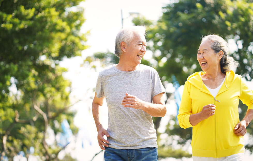 Mature Asian couple jogging outside for exercise