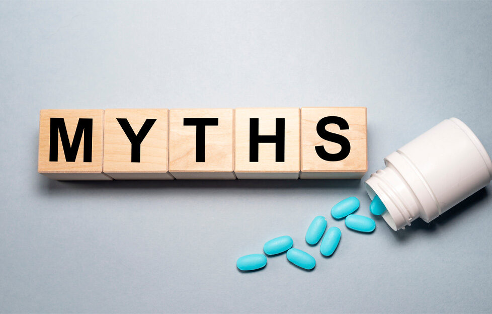 MYTHS spelled out in letter blocks with a bottle of spilled blue pills to demonstrate health myths