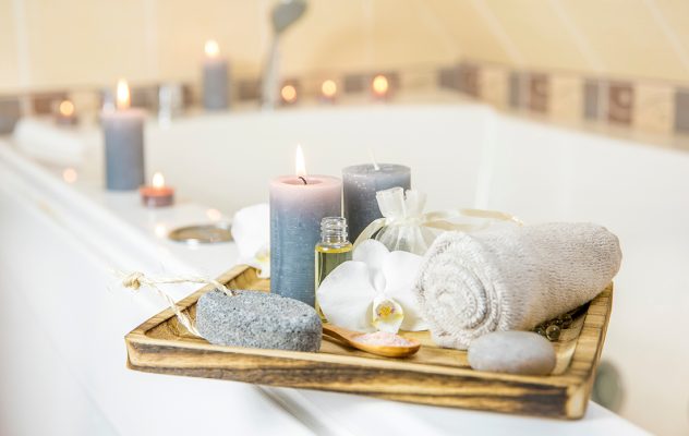A bath with candles and a soft towel to help beat insomnia