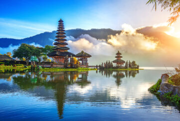 Temple in Bali, Indonesia on a bright blue sky day and sunlit mist rolling in