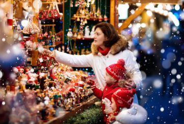 woman and children shopping at christmas market