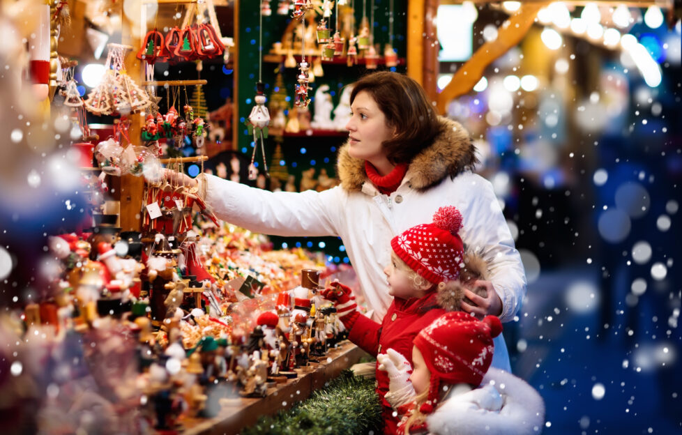 woman and children shopping at christmas market