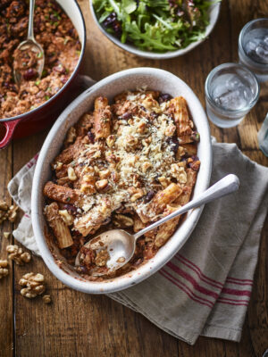 Chilli California Walnut pasta bake recipe with casserole dish of pasta bake, pot of mince, bowl of salad and glasses of water